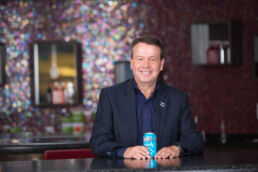 Cott Beverages CEO Jerry Fowden sitting with soft drink - Carver Mostardi Photography - Tampa corporate portraits.