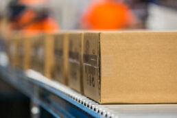 Packages on conveyer belt at Jagged Peak fulfillment operations in St. Petersburg, Florida - commercial photography Tampa - Carver Mostardi Photography.
