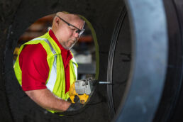 Working on the pipe at the Wolseyley Industrial Group, Industrial photography Lakeland, Florida by Tampa based commercial photographer Carver Mostardi.