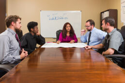 Group of engineers discuss plans in Atlanta, Georgia.