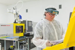 Lab technician checking commercial product specs on industrial factory plant floor at Seaway Plastics in Pasco County, Florida.