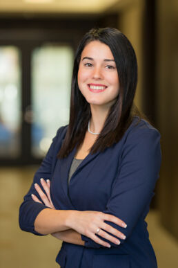 Female engineer with her arms crossed at engineering firm's office for team member headshots in St. Petersburg, Fl.