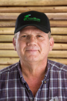 Paperworks Industries employee photographed with wooden beams by Tampa Commercial photographer Carver Mostardi.