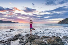 Woman doing sunset yoga in Playa del Coco, Costa Rica by Tampa commercial photographer Carver Mostardi.