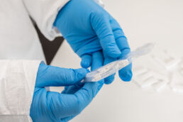 Close up of medical lab tech examining test results at Orlando industrial laboratory.