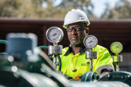 Service technician checking water valves at industrial wastewater treatment plant in Orlando, FL.