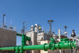 Service technician overlooking water pipes at an industrial wastewater treatment plant in Orlando, FL.